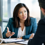 Executive challenging assumptions during high-stakes negotiation